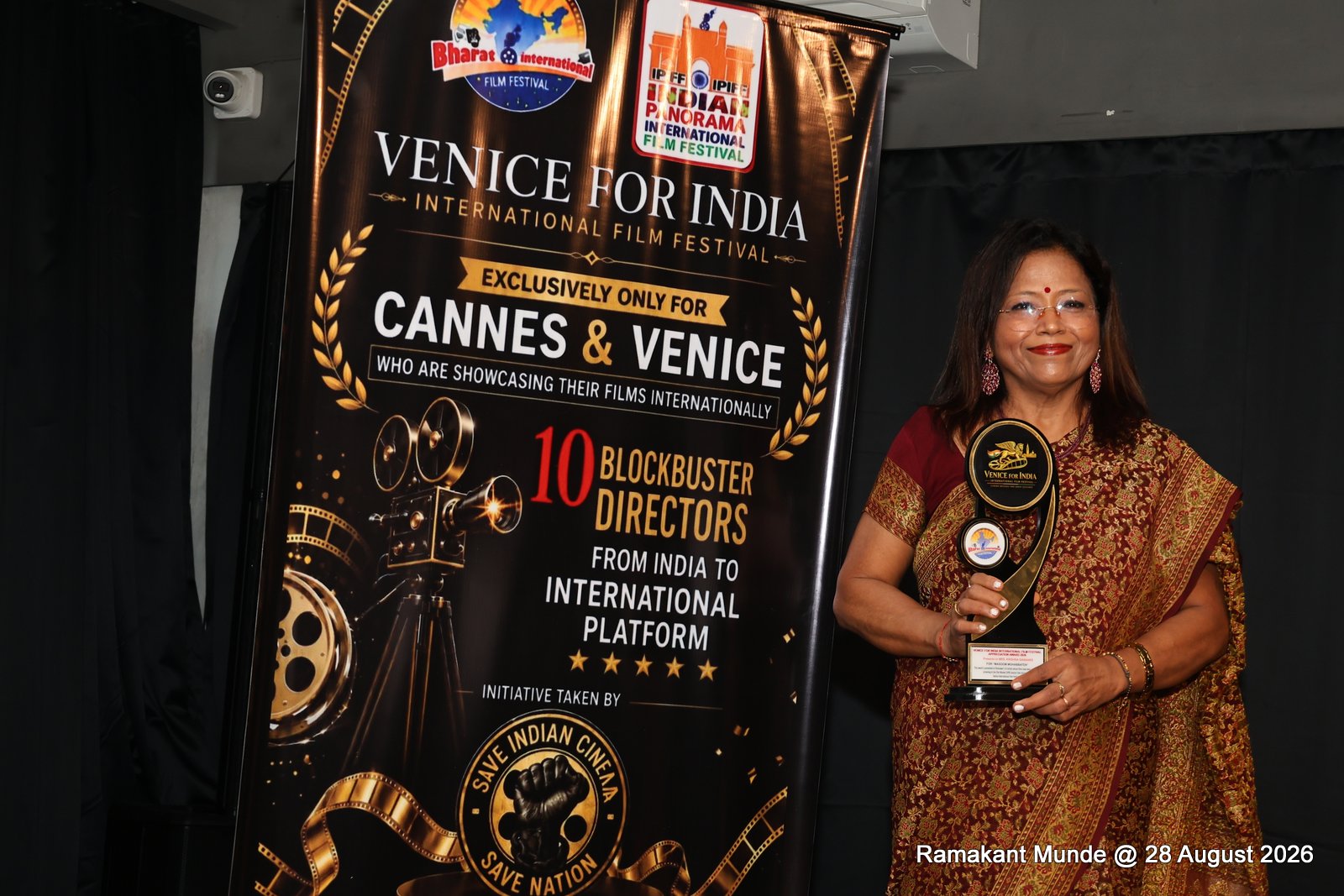 Krishna Sainanee holding Venice for India International Film Festival Trophy
